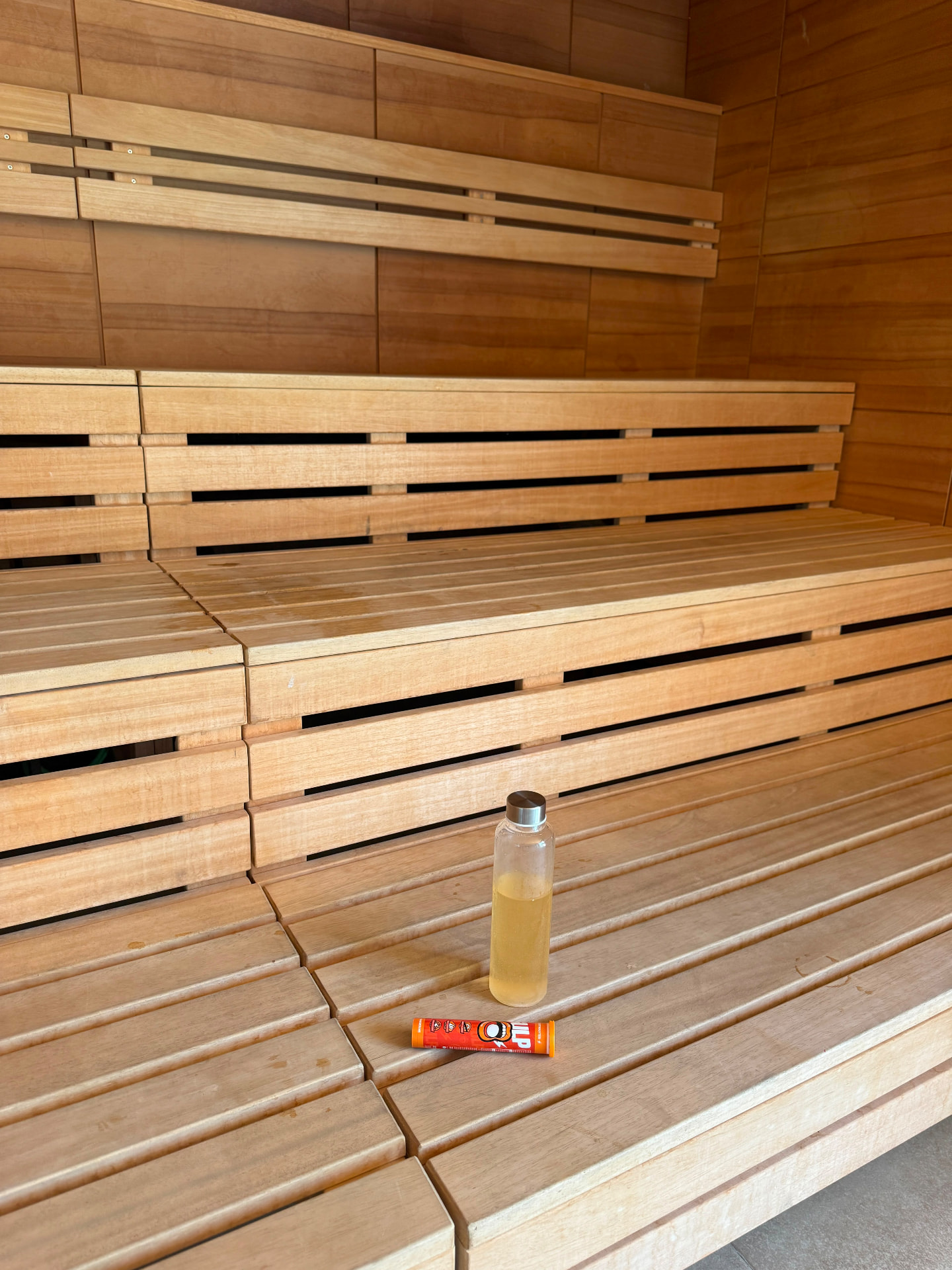 GULP tube and water bottle on a sauna bench
